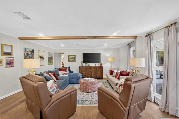 wood floors and generous natural light create an inviting living room.