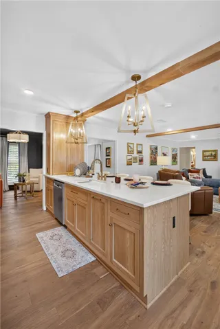 Custom cabinetry and warm wood floors define this inviting kitchen space, perfect for entertaining.