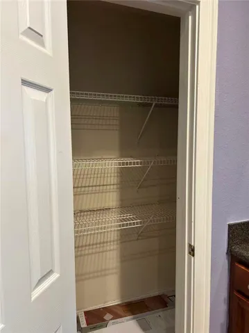 Maximize organization with this functional pantry, featuring ample wire shelving.