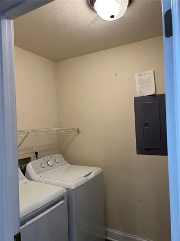 A well-appointed laundry area offers convenient appliance hookups and practical overhead shelving.