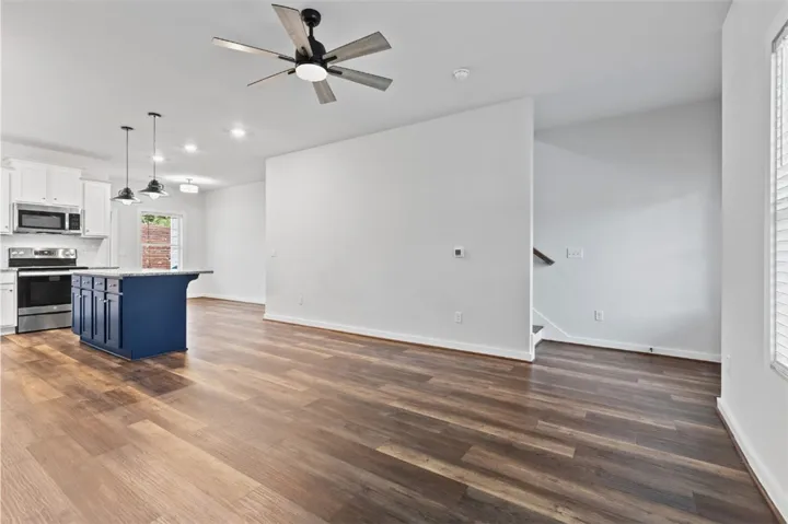 Open concept great room includes living room, kitchen and dining area.