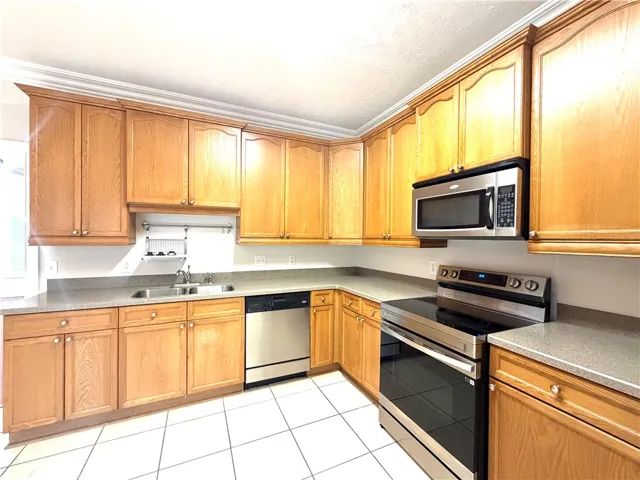 A well-appointed kitchen showcasing ample cabinetry and essential appliances for everyday living.