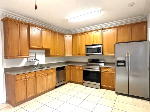 Culinary delights await in this well-appointed kitchen, featuring ample cabinetry and essential appliances.