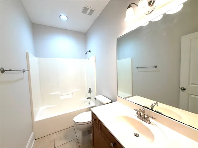 A well-appointed bathroom features a practical vanity and a combined tub and shower for everyday ease.