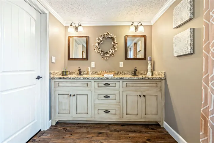 Double vanity and elegant fixtures define this well-appointed primary bathroom.