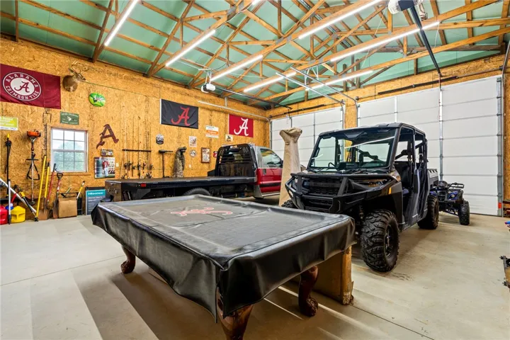 A spacious garage, perfect for hobbies and storage, includes multiple large roll-up doors.