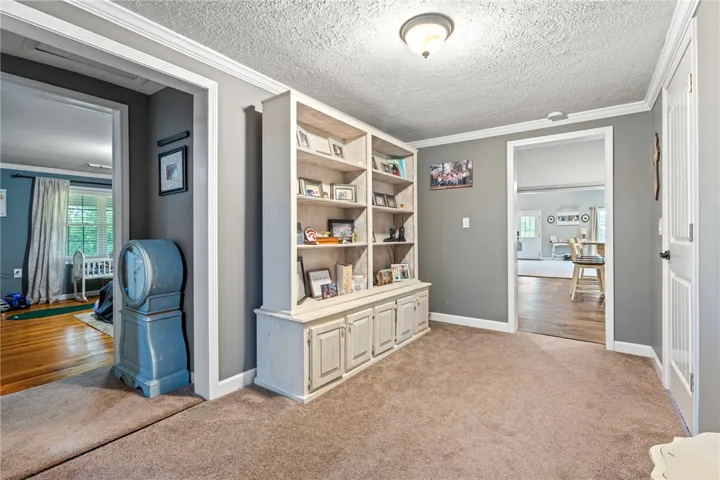 Built-in shelving provides ample storage in this inviting, carpeted interior space.