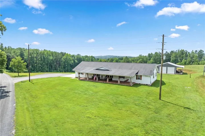 A spacious ranch home awaits on a generous, verdant parcel with a detached garage.