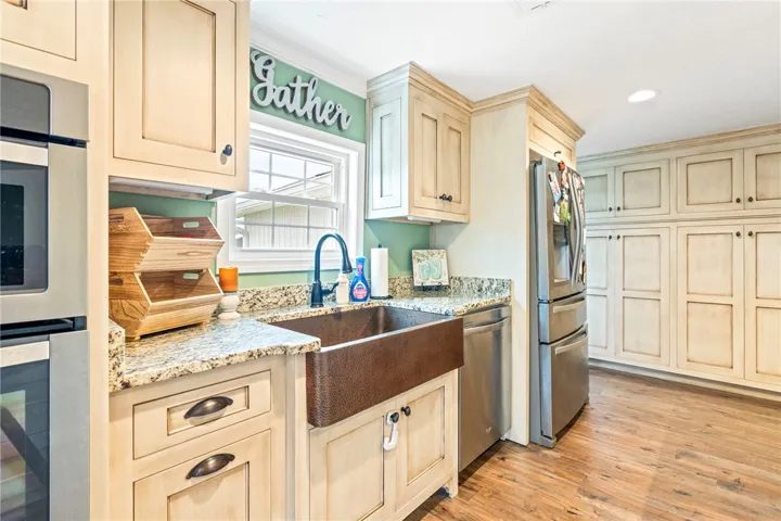 Culinary haven with granite counters and an elegant copper sink.