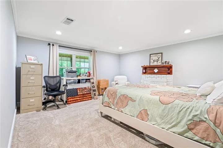 A versatile room provides a comfortable sleeping area alongside a dedicated workspace.