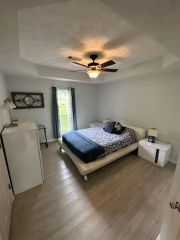 Well-lit sleeping quarters offer tray ceilings and durable plank flooring.
