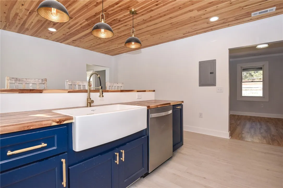 A well-appointed kitchen features a deep basin sink and rich wooden countertops.