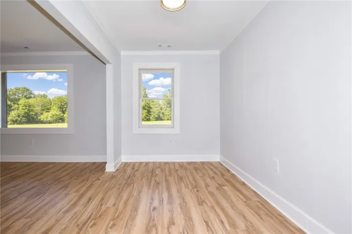 Hardwood-style flooring and pristine walls await your personal touch in this airy space.