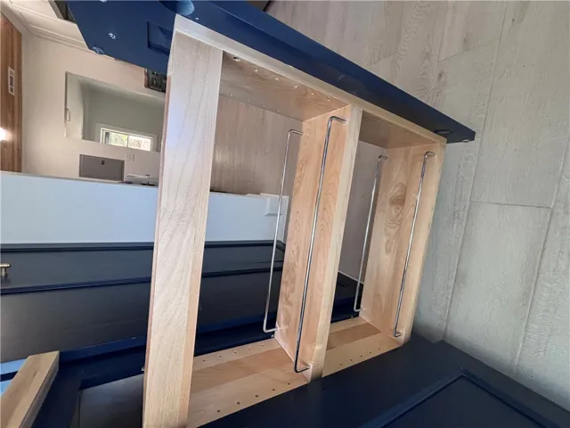Custom cabinetry and hardwood flooring create a sophisticated storage solution.