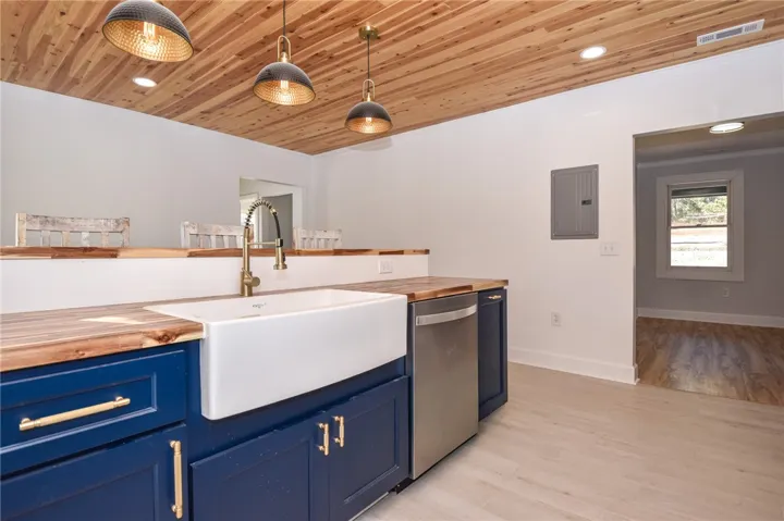A well-appointed kitchen features a deep basin sink and rich wooden countertops.