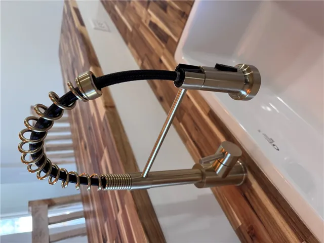 A sleek, pull-down faucet and sink perfectly complement the warm wood paneling.
