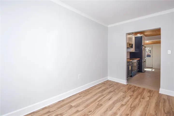 Natural wood flooring complements the freshly painted walls, creating a welcoming atmosphere.