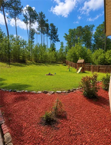 A fenced backyard and dedicated play area
