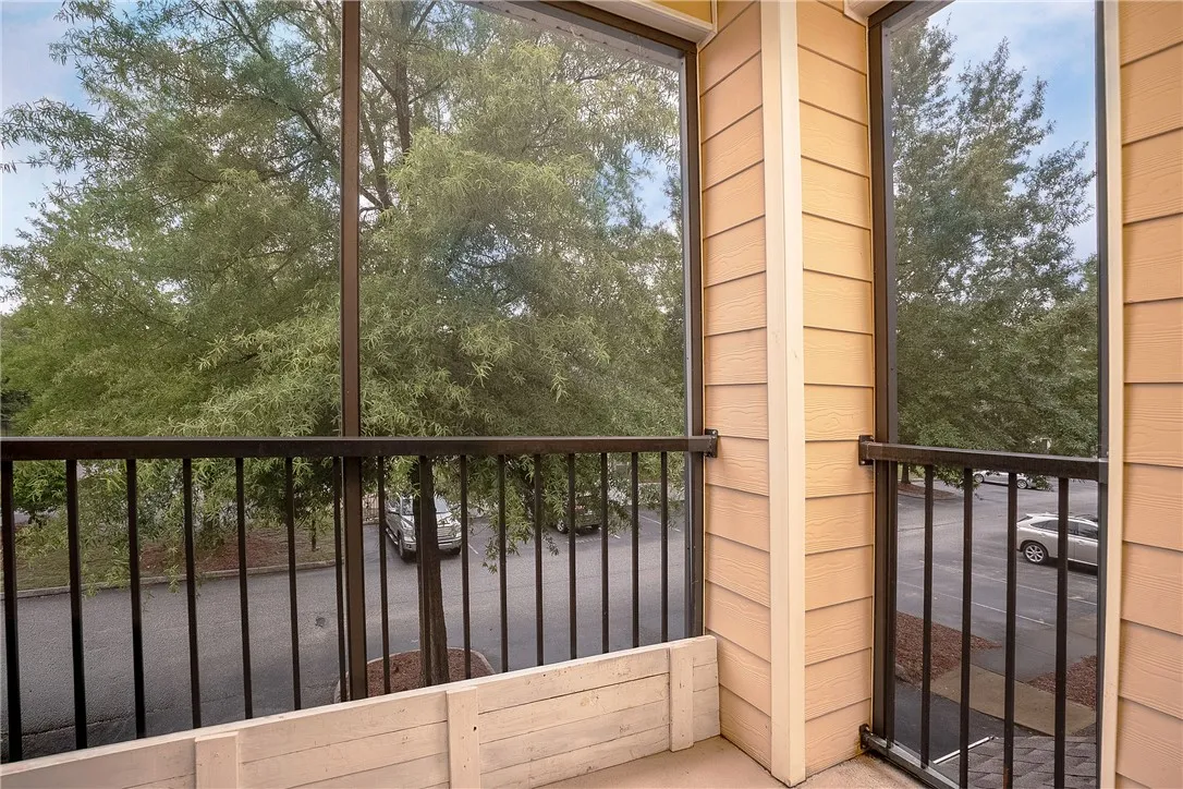 A private balcony offers serene tree-lined views, perfect for peaceful mornings.