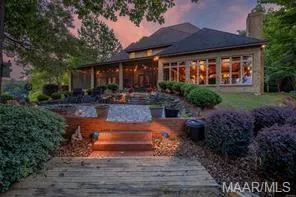 Entertain guests on the covered patio overlooking a pool and the manicured grounds of this remarkable estate.
