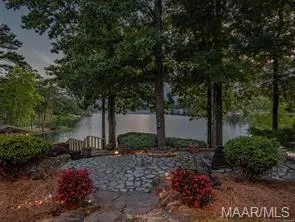 A tranquil lakefront oasis offers direct water access and a serene natural setting.