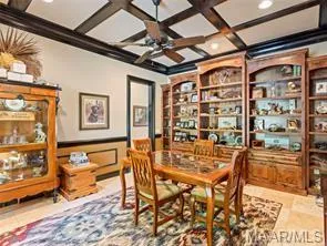 Rich wood built-ins and coffered ceilings define this stately study.