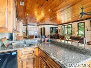 Granite counters and rich wood cabinetry define this gourmet kitchen.