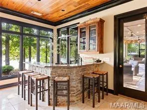 An inviting wet bar with natural light offers seamless indoor-outdoor entertaining.