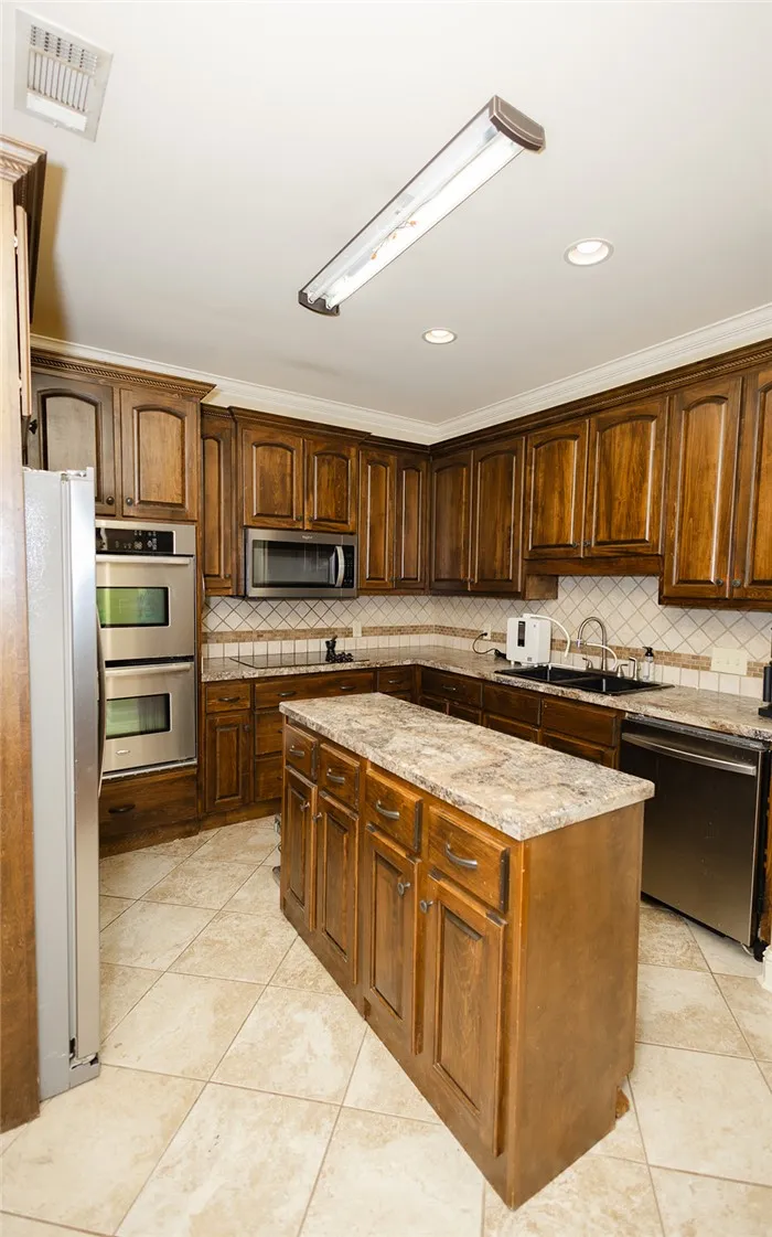 Custom cabinetry and modern appliances define this well-appointed kitchen, ideal for culinary creations.