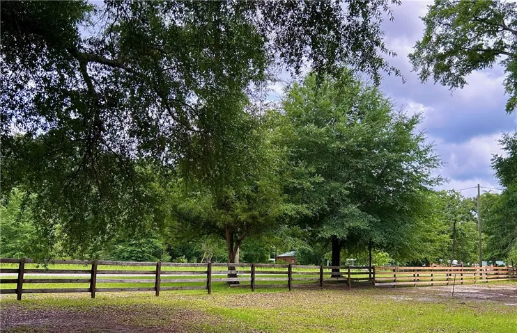 A spacious, fenced property provides ample green space.