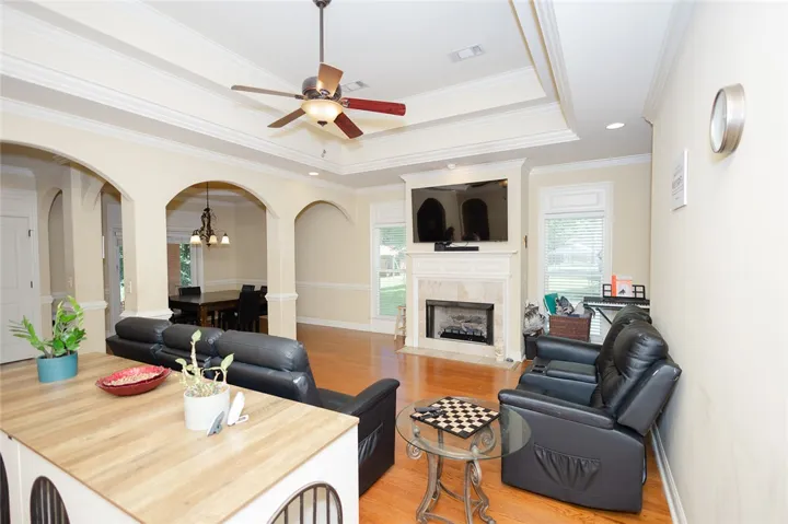 Hardwood floors and graceful archways define this elegant, inviting living space.