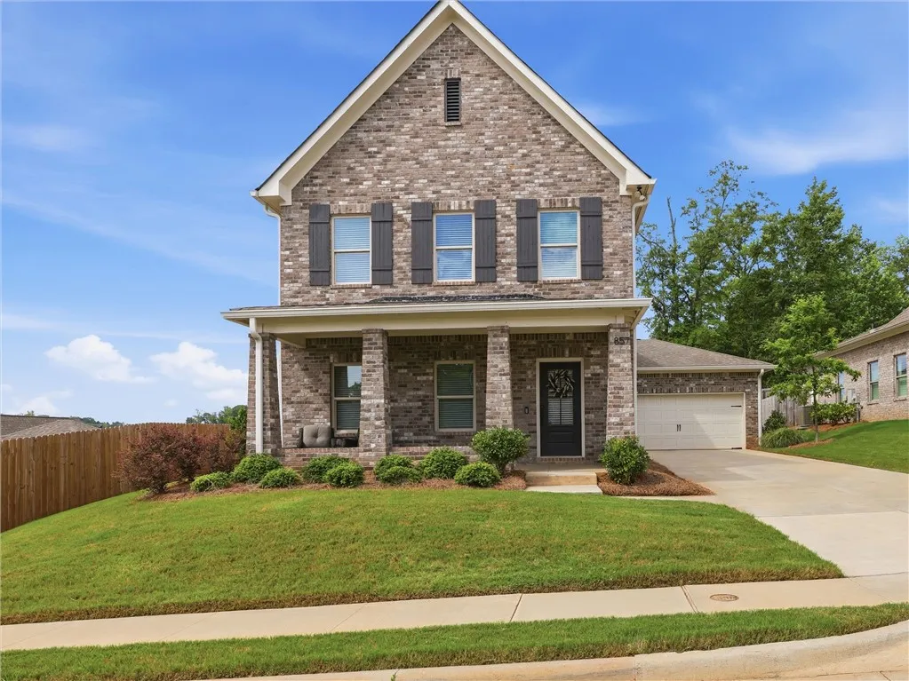 A classic brick facade and inviting front porch define this charming suburban residence.