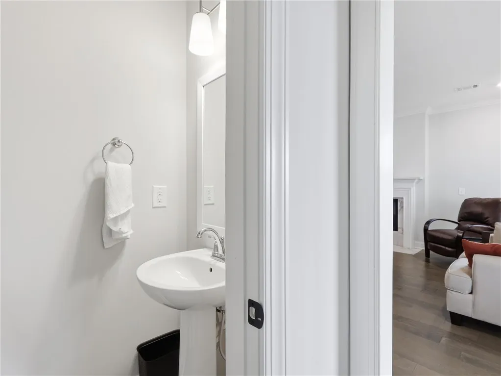 A pristine powder room with modern fixtures, offering a clean and functional space.
