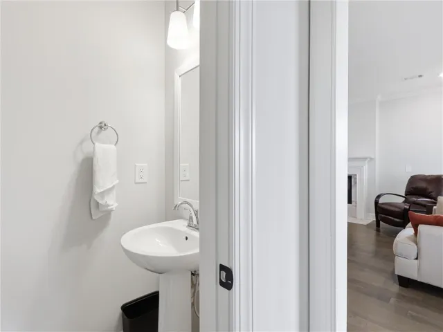 A pristine powder room with modern fixtures, offering a clean and functional space.