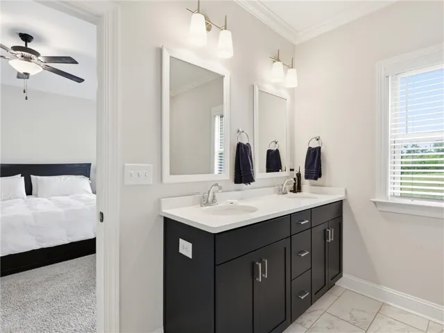 Dual vanities and pristine finishes define this bright, functional bathroom.