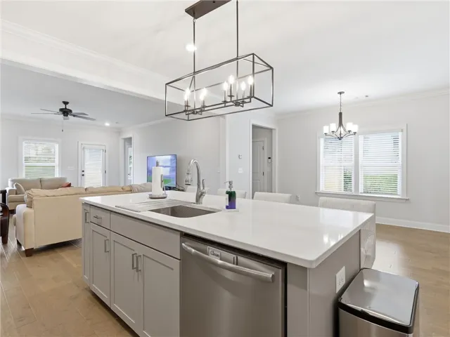 A well-appointed kitchen island with gleaming counters anchors this open-concept living space.