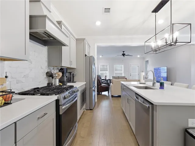 Bright, modern kitchen with sleek appliances and an inviting open concept connecting to the living area.