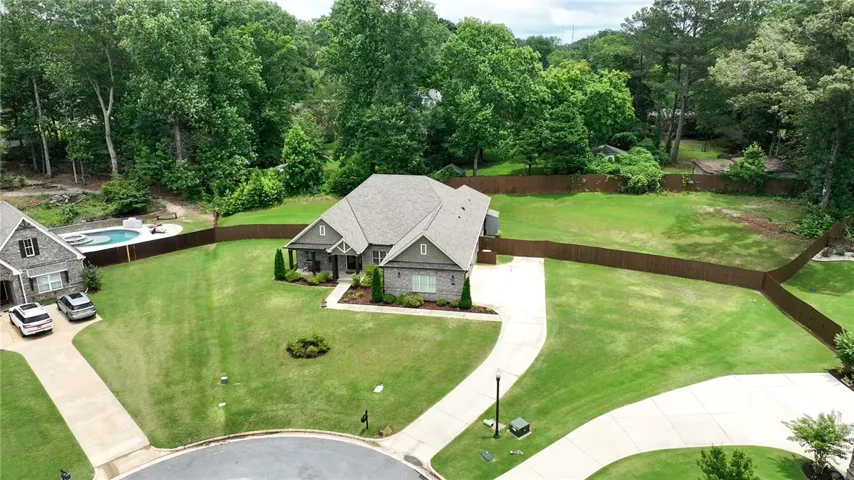 A sprawling lawn surrounds this elegant home, complete with a private pool and ample outdoor space.