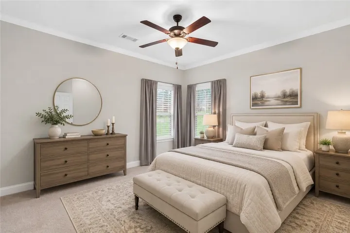Well-appointed sleeping chamber boasts a ceiling fan and generous natural light from two windows. Virtually staged