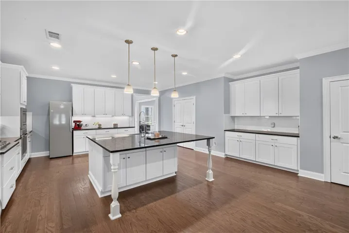 Culinary dreams come alive in this kitchen, featuring an oversized island and ample cabinetry.