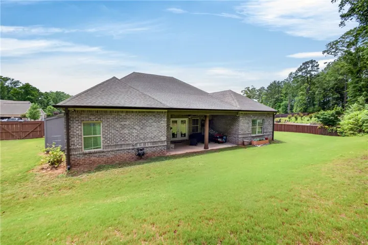 A spacious lawn unfolds behind this classic brick home, inviting outdoor enjoyment.