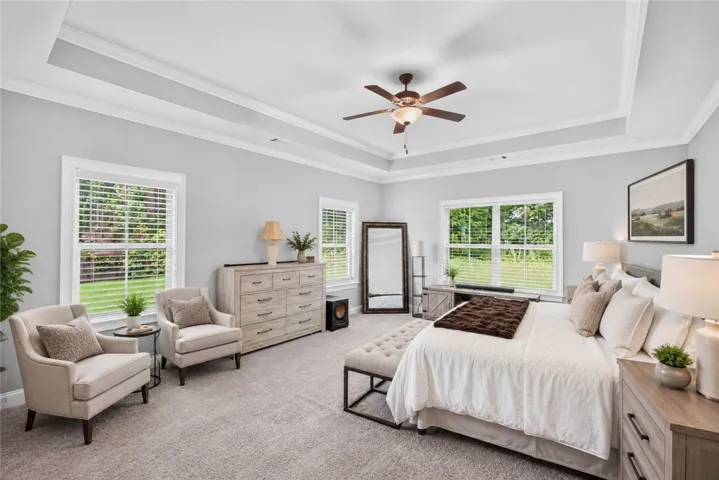 Step into a generously sized bedroom featuring high ceilings and ample natural illumination. Virtually staged