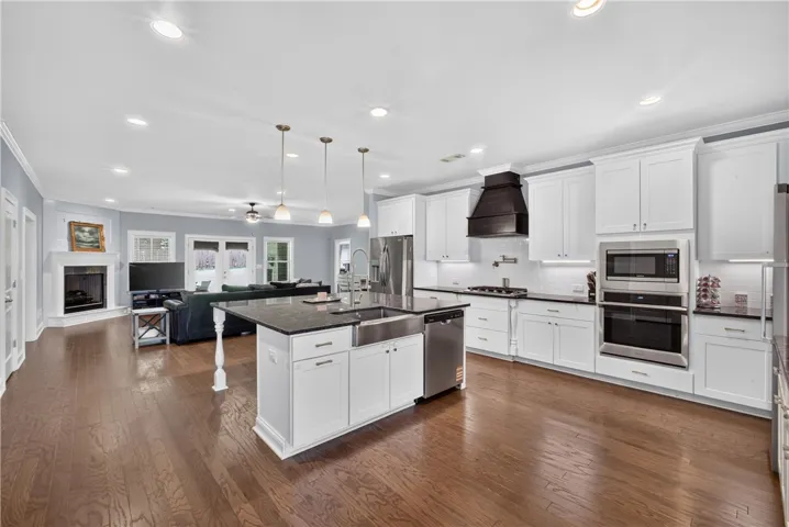 A pristine open-concept kitchen and living area, complete with a generous island and sleek appliances.