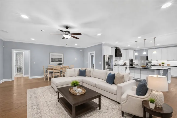 An open concept floorplan connects the living room, dining area, and a chef's kitchen, perfect for entertaining. Virtually staged