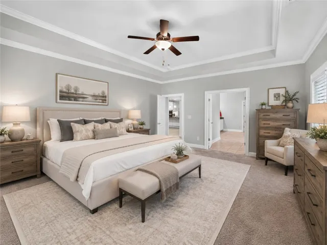 Recessed tray ceiling with crown molding creates an inviting atmosphere in this generous sleeping retreat. Virtually staged