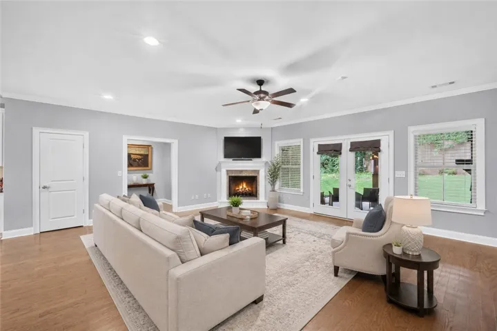 Hardwood floors complement a cozy fireplace and French doors leading to a private yard. Virtually staged