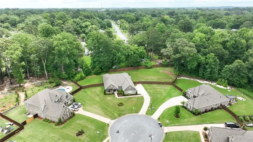 Cul-de-sac properties offer privacy and expansive lawns surrounded by natural tree lines.