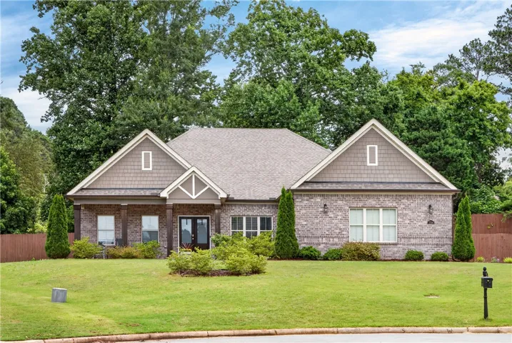 A classic brick exterior with a welcoming porch defines this charming residence.