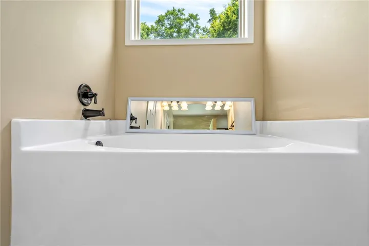 Unwind in the large soaking tub, perfectly situated under a window for natural illumination.