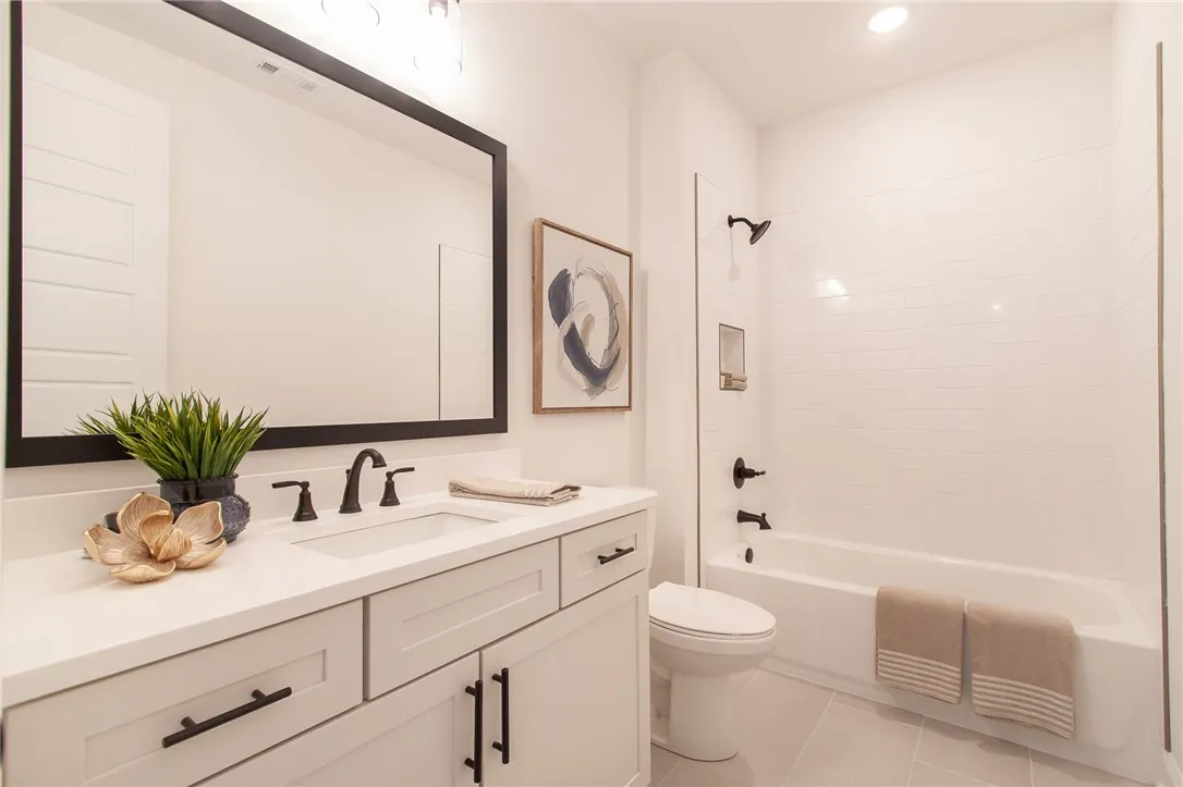 Modern fixtures and white subway tile create a serene and functional bathroom.Photos are not of subject property. Photos are of the same floorplan of a completed home.
